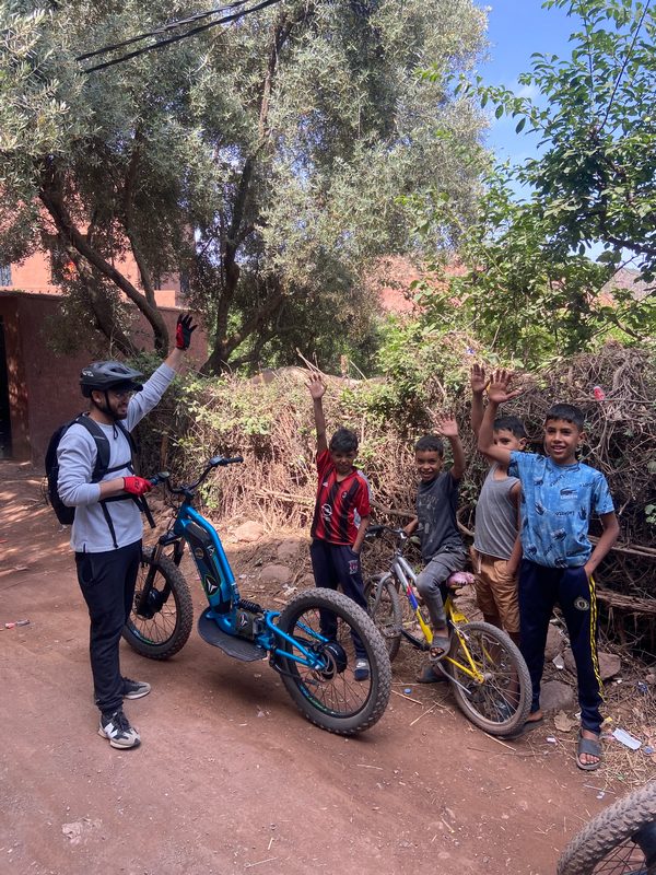 A rider on a technical off-road electric scooter descent in the Ourika valley