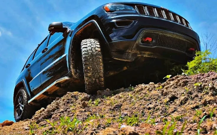 Black Jeep 4×4 climbing a rocky hillside track