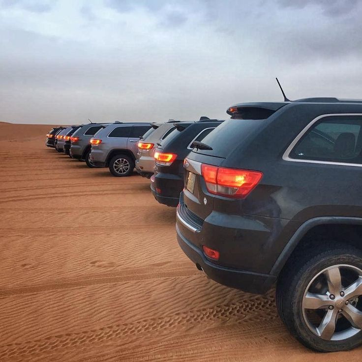 Line of Jeep 4×4 vehicles on desert sand in Morocco