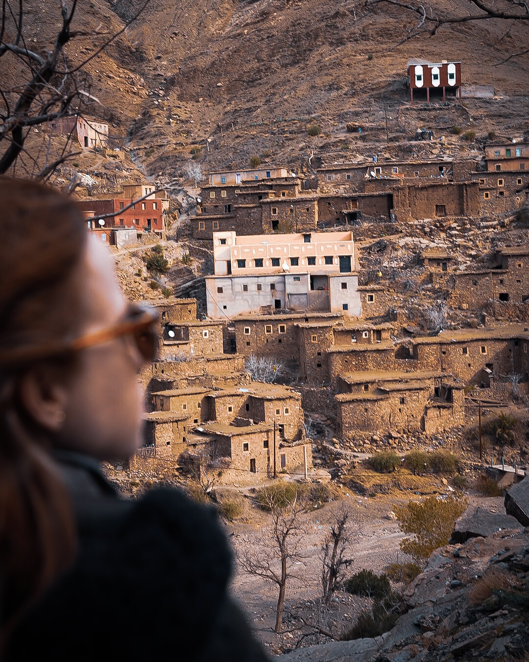 A stone and earth Berber village stacked up a steep High Atlas hillside