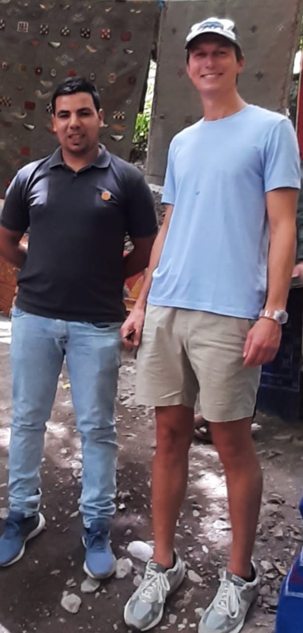 Mustapha Amazouz standing with a guest in the Imlil valley at the end of a trip