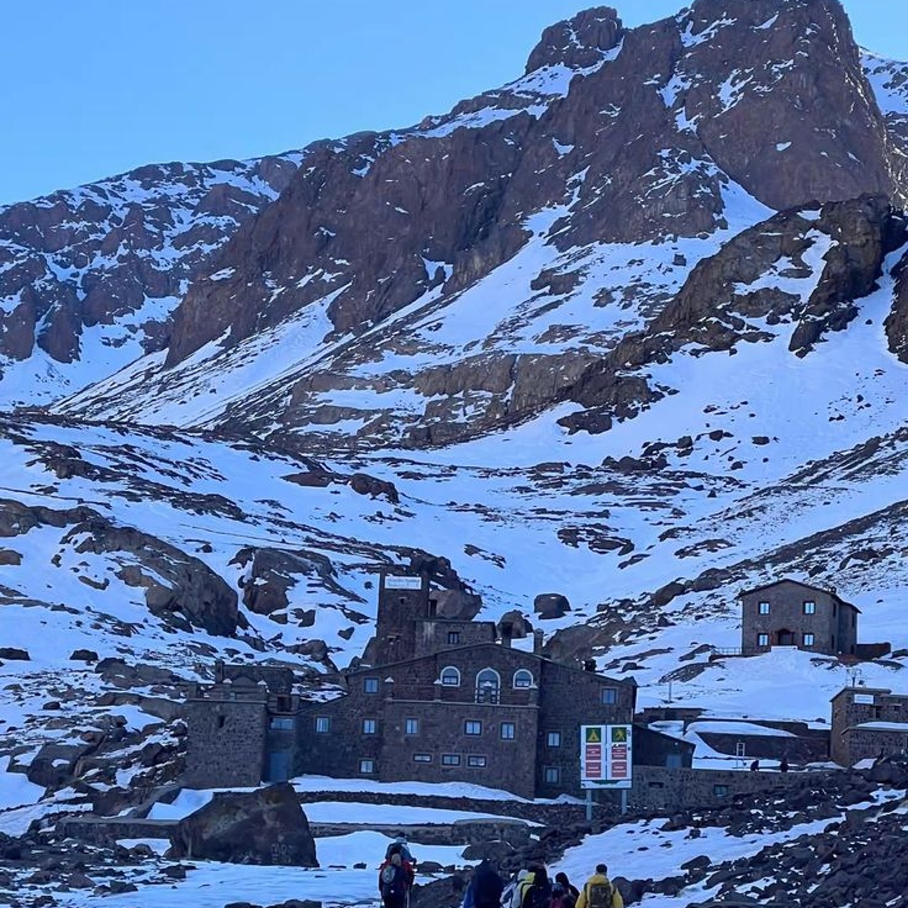 The Toubkal refuge below snow-covered rock faces