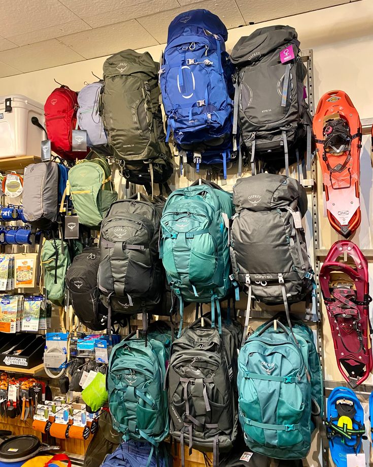 Trekking backpacks and snowshoes on an equipment wall in Imlil