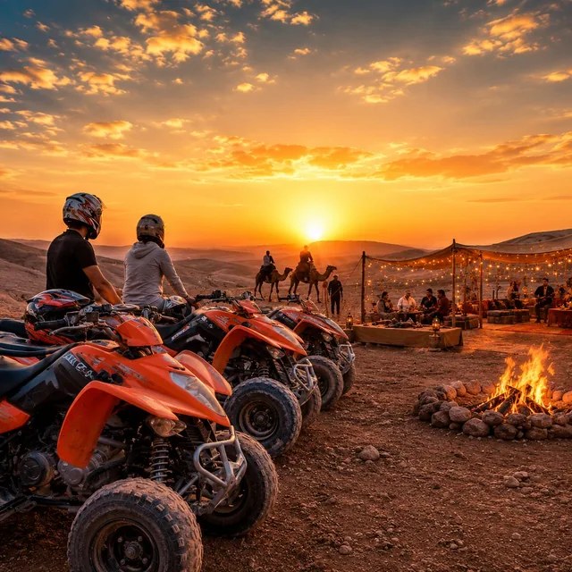Quad riders watching the sunset beside a camp fire pit with camels and a lit dinner tent behind