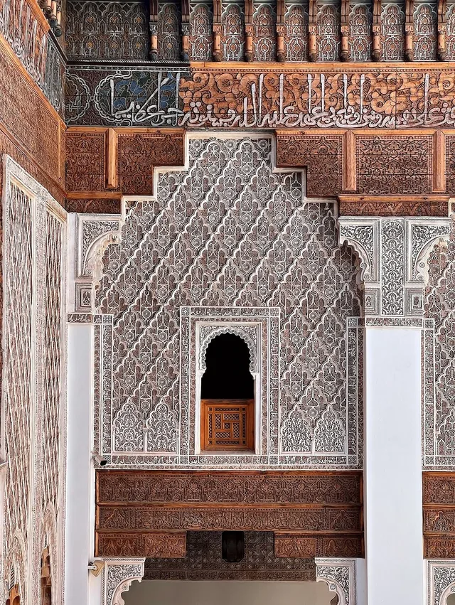 Carved stucco, cedar and calligraphy panels inside the Ben Youssef Madrasa in Marrakech