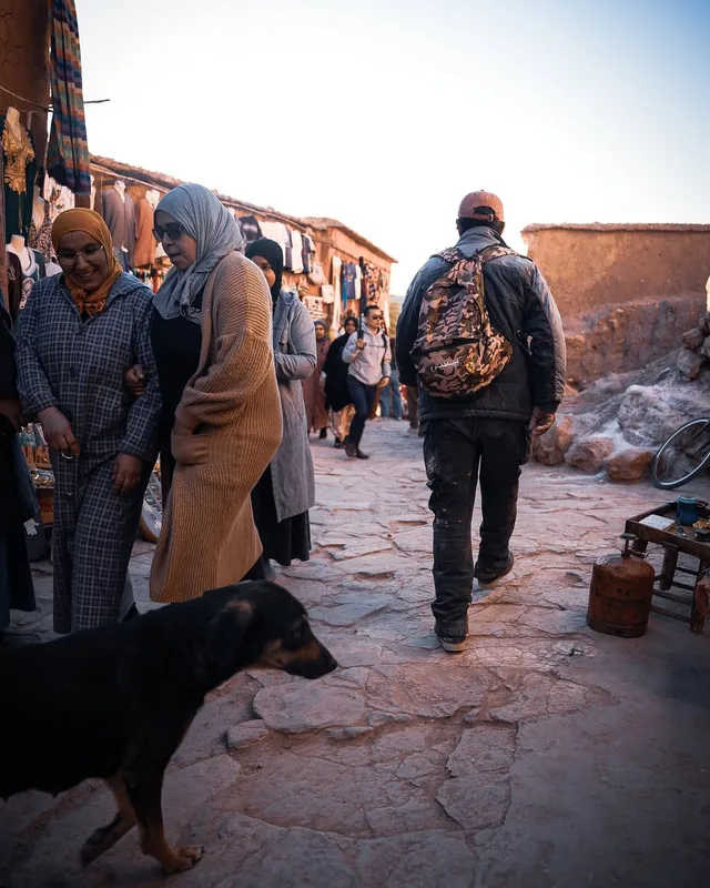 Villagers and visitors walking a stall-lined stone lane inside the Aït Ben Haddou ksar