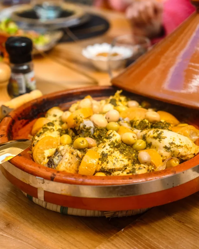 Chicken tagine with green olives, chickpeas and preserved lemon in a clay dish