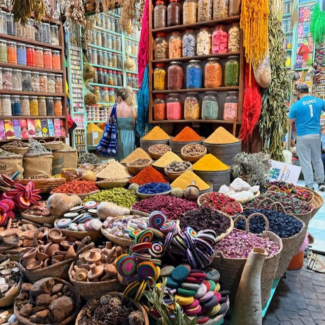 A Marrakech herbalist shop with spice cones, dried rosebuds and jars of pigments and herbs
