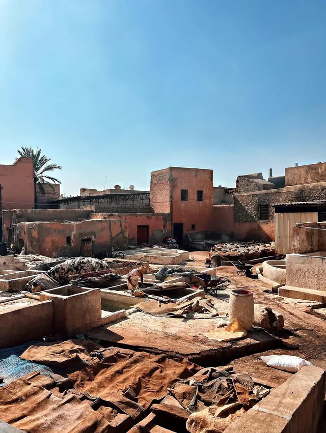 Marrakech tannery pits and drying hides seen from a rooftop under a blue sky