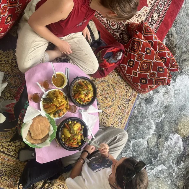 Vegetable tagines, bread and mint tea shared on a low table right next to the river rapids
