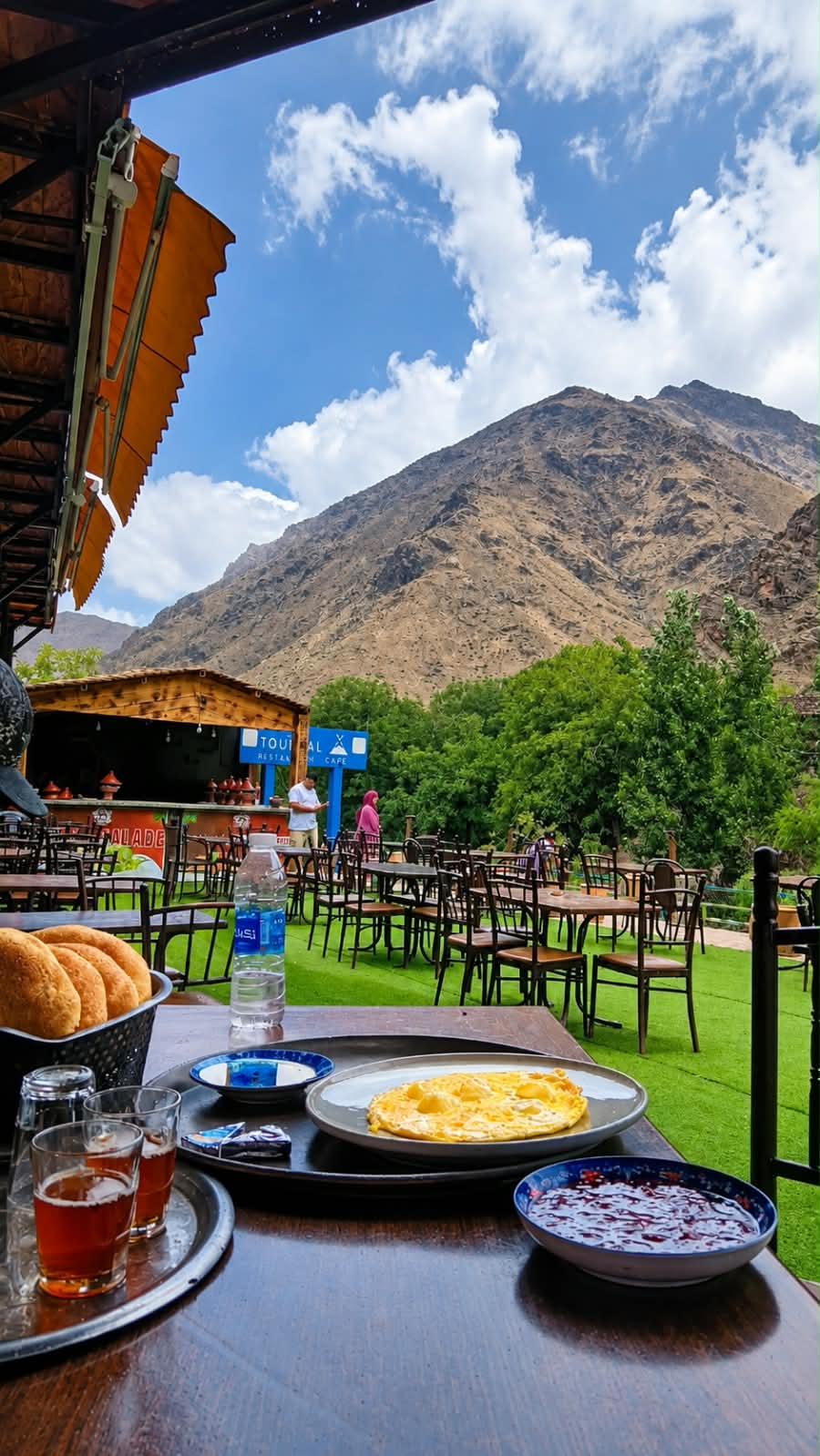 Breakfast with mint tea, bread and an omelette on the Restaurant Targa terrace in Imlil, with the Atlas mountains behind