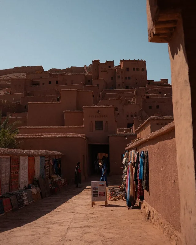 Berber rugs and scarves hung along the lane leading up to the Aït Ben Haddou ksar
