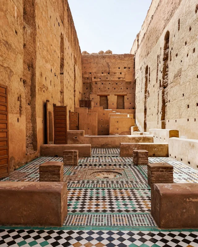 The sunken mosaic courtyard of El Badi Palace framed by tall pisé walls