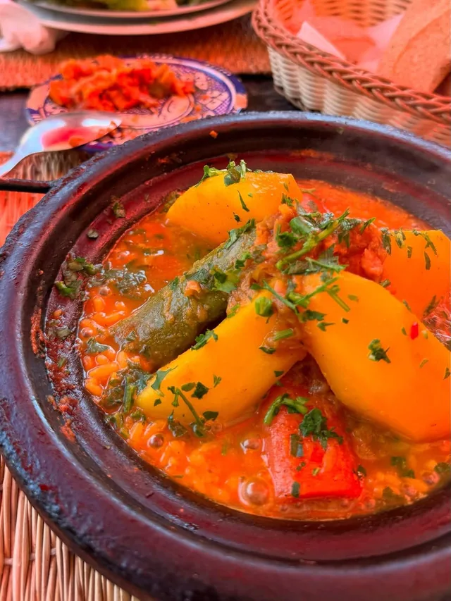 A vegetable tagine with potato, courgette and coriander served with bread and salad